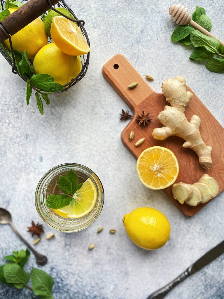 ginger root with lemon, star anise, and mint in a glass
