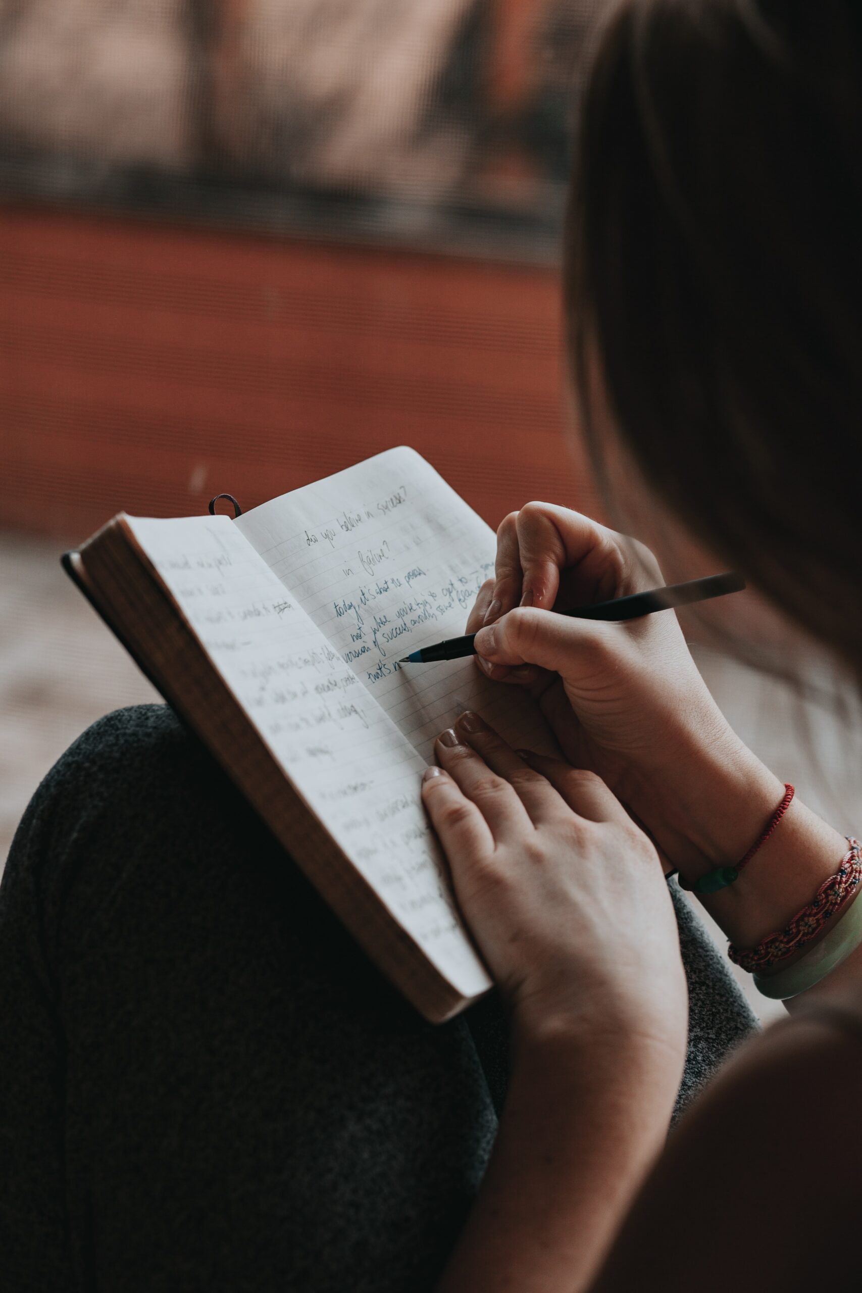 a woman writing down her goals for the new year