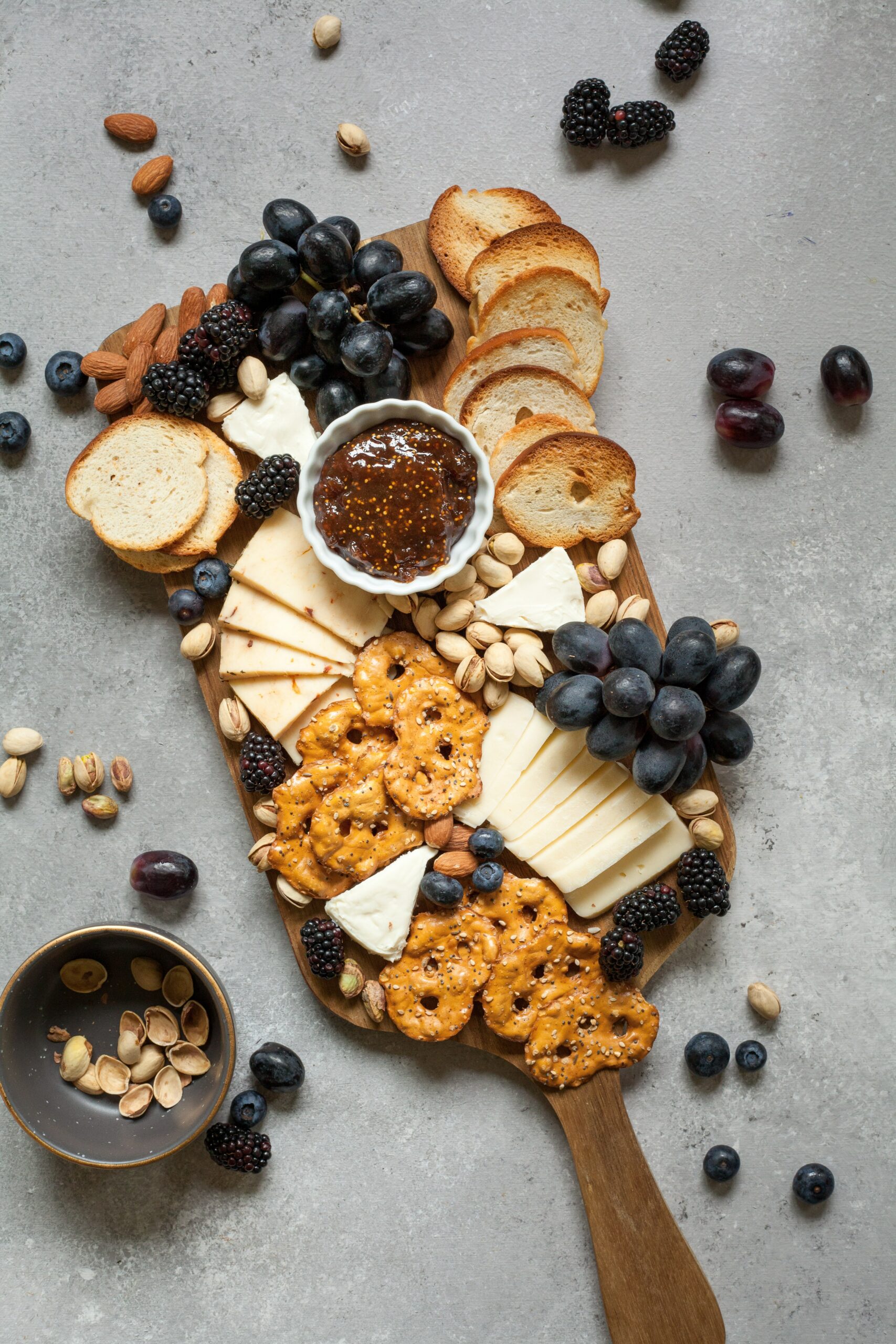 charcuterie with bread, pretzel crackers, cheese, and fruit_high protein dinner ideas