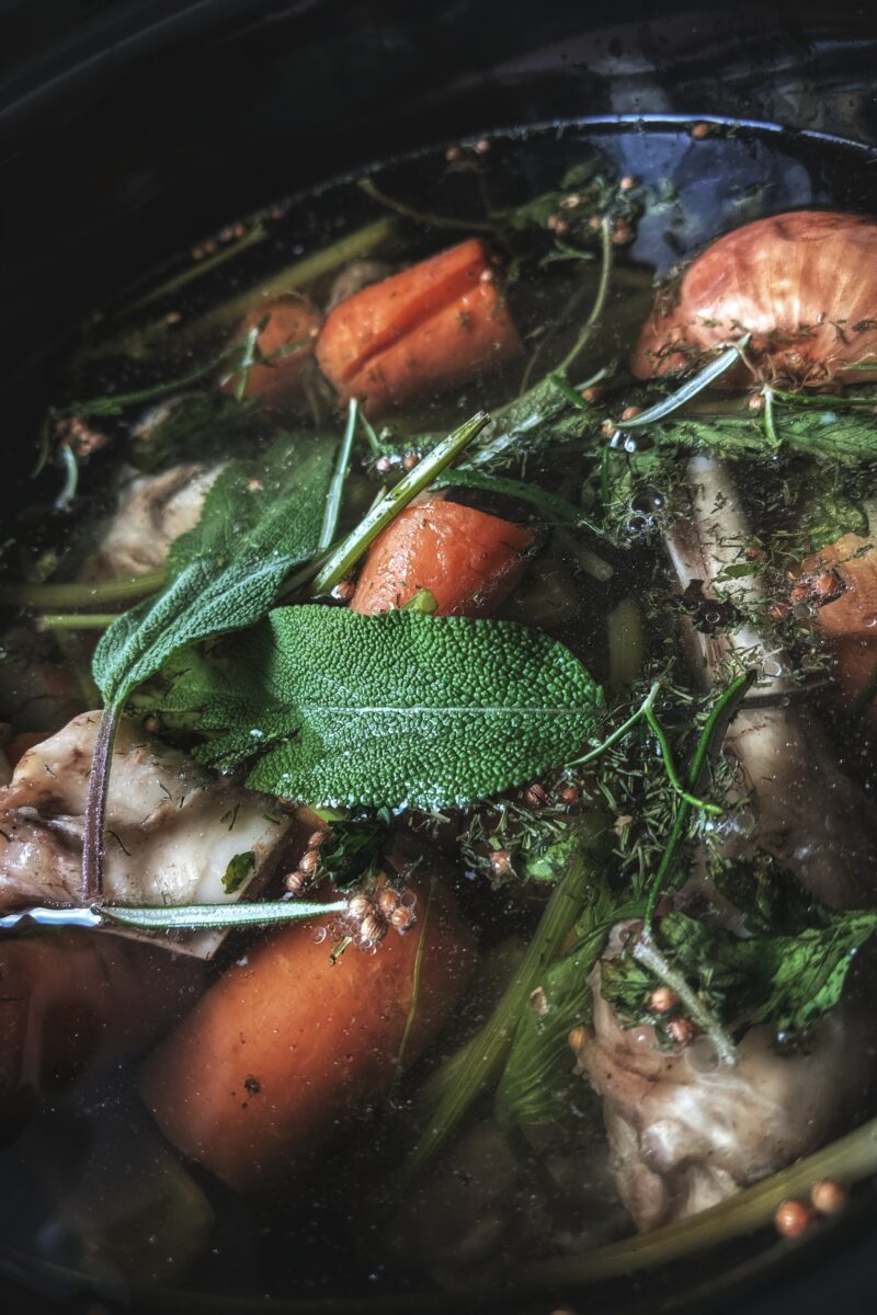 pot of soup with vegetables and bone broth_bone broth for milk supply